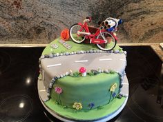 a birthday cake with a bicycle on top