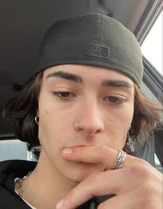 a young man is sitting in the back seat of a car with his tongue hanging out