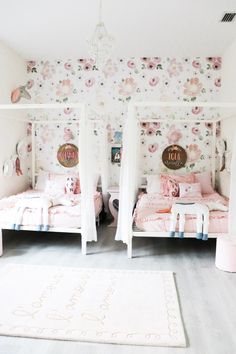 two twin beds in a girls room with floral wallpaper