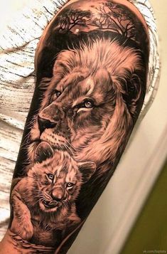 a man with a lion and cub tattoo on his arm