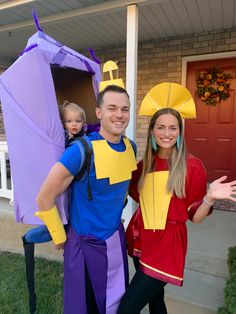 a man and woman dressed up in costumes posing for the camera with a child on his back