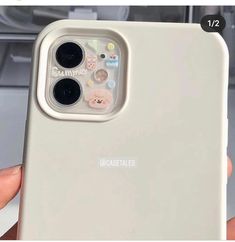 someone is holding up their phone case with the camera lens cover on it's back