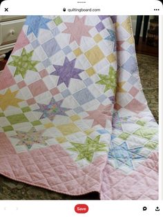 a pink and green quilt with stars on it