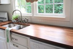 a kitchen with a sink, stove and window