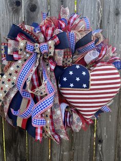 a patriotic heart wreath hanging on a fence