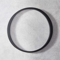 a black rubber ring sitting on top of a white surface