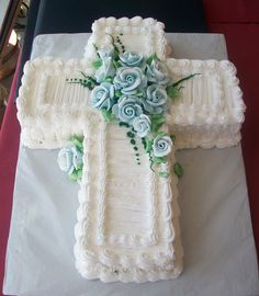 a cake decorated with flowers and a cross