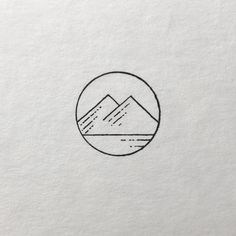 a black and white drawing of mountains in a circle on top of a piece of paper