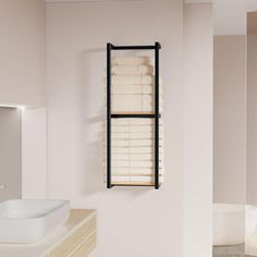 a bathroom with a sink, mirror and towel rack hanging on the wall above it