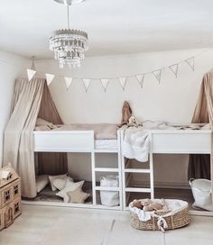 a bedroom with bunk beds and curtains on the ceiling, lights hanging from the ceiling