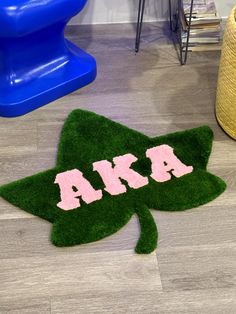 a green rug with pink letters on it