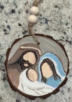 a wooden ornament with an image of two people in the center on a marble surface