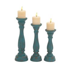 three teal colored candles sitting next to each other