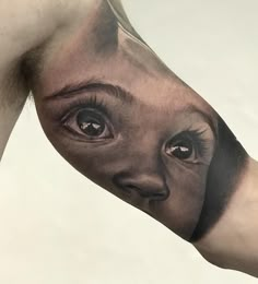 a man's arm with an eye tattoo on it