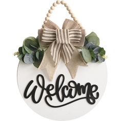 a welcome sign with a bow on it