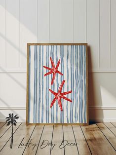 a red starfish sitting on top of a wooden floor next to a palm tree