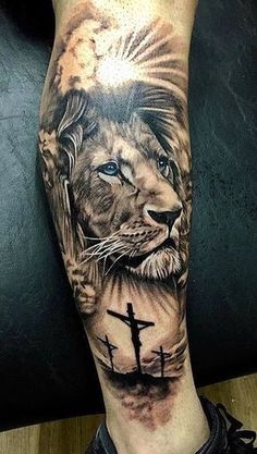 a man's arm with a lion and cross on it