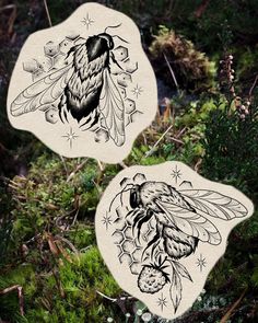 two stickers with bees on them in the woods