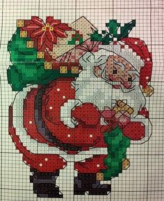 a cross stitch christmas scene with santa claus