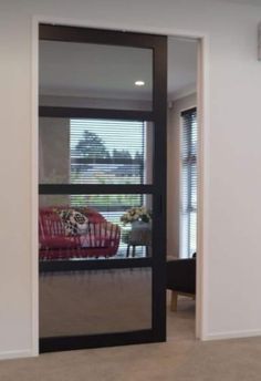 an empty room with sliding glass doors leading to the living room and dining room area