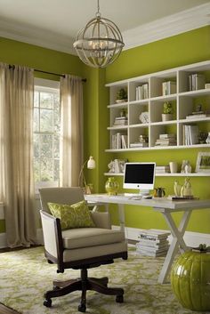 a home office with green walls and white furniture