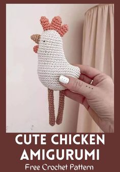 a crocheted chicken amigurmi is being held up by someone's hand