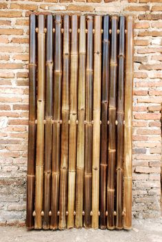 an image of a bamboo fence in front of a brick wall