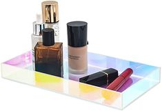 an acrylic tray with cosmetics and lipstick on it