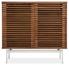 a wooden cabinet with slatted doors and metal legs on an isolated white background