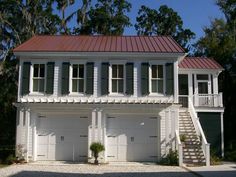 two story white house with red roof and shuttered windows