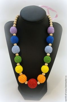 a multicolored beaded necklace on a mannequin