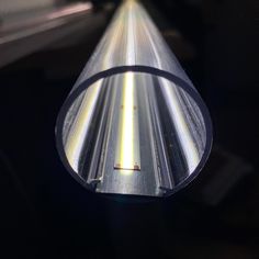 a close up view of a metal tube with light shining on it's side