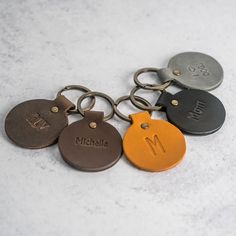 six personalized metal key chains with the letter m on them