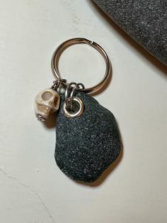 a key chain with a rock and a skull on it