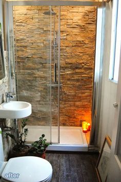 a bathroom with a toilet, sink and shower stall in it's own area