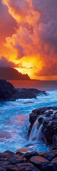 the sun is setting over the ocean with waves crashing in front of rocks and cliffs