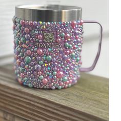 a purple coffee cup with beads on it