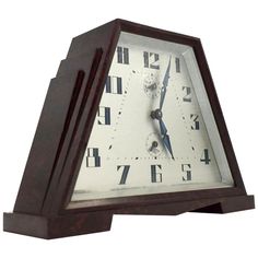 an old fashioned wooden clock with roman numerals