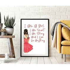 a poster with the words i am a girl on it next to a chair and potted plant