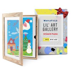 three wooden frames with artwork on them, one has a santa clause and the other is a snowman