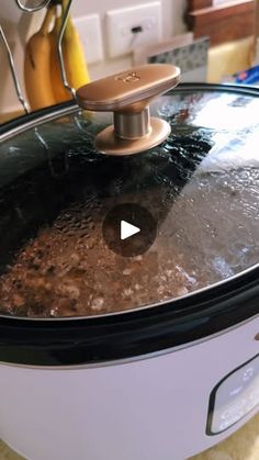 a slow cooker filled with food on top of a counter