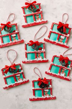 christmas ornaments made out of frames with red bows