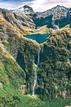 an aerial view of a waterfall in the mountains