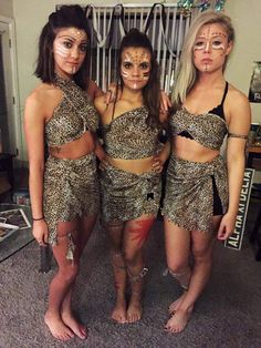 three women dressed in costumes posing for the camera