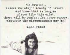 a woman laying on top of a sandy beach next to a quote from anne frank