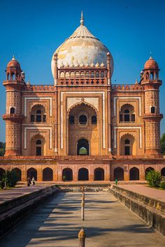 an old building with a large dome in the middle of it's front yard