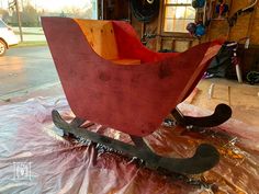 a wooden sled sitting on top of a tarp