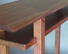 a close up of a wooden table with two shelves on each side and one shelf at the top