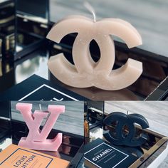 the chanel candle is next to some other items on display in front of them