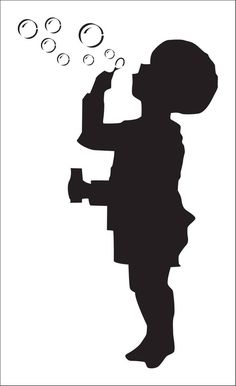 the silhouette of a child blowing bubbles